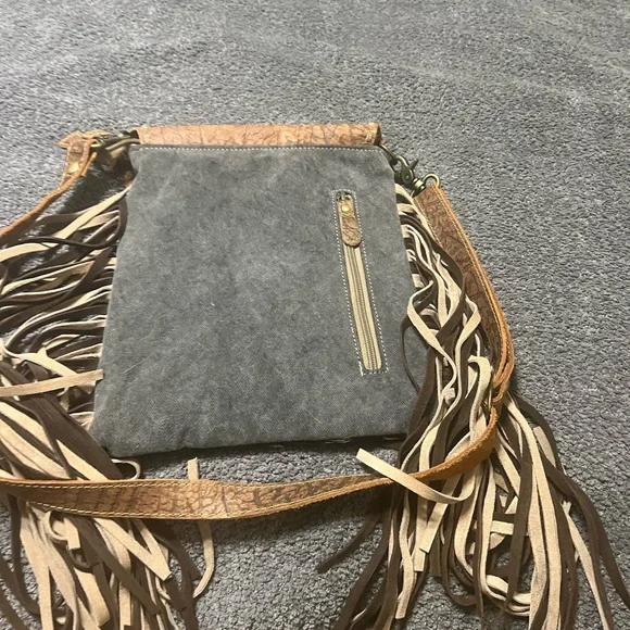 Myra cross body cow hide and leather with tassels. Also has concealed carry